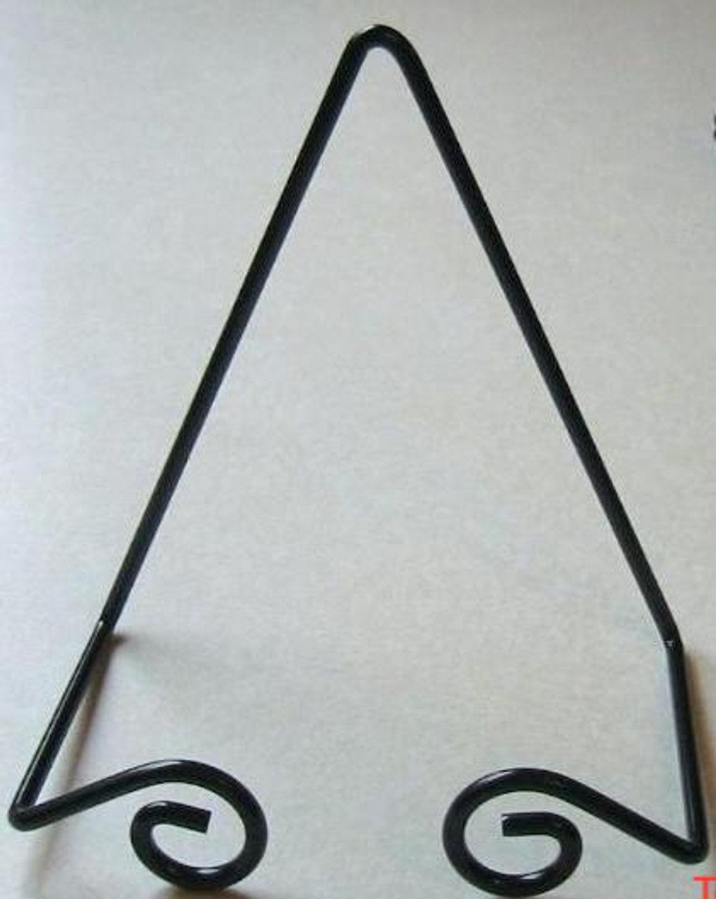 Black Small Wrought Iron Plate Hanger showing the plate hanger on a counter top.
