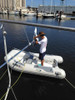 Pivoting pole kit mounted on the transom allows access to wind generator from the dinghy or dock.  (Courtesy of Mitzi and Alain Gimenez on S/V Holiday)