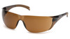 Carhartt Billings® Safety Glasses (CH118S) shown in a 3/4 front view. Features the lightweight frameless design with a Sandstone Bronze polycarbonate lens, ideal for enhancing contrast and visibility in low-light or hazy conditions. The frame/temples are a translucent brown color and include comfortable rubber temple tips (TPR). These high-impact, frameless safety glasses are certified to ANSI Z87.1 and CSA Z94.3 standards.