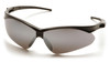 A high-definition 3/4 view of the Pyramex PMXTREME SB6370SP safety glasses, featuring a sleek silver mirror lens paired with a durable black nylon frame. The silver mirror coating is specifically engineered for outdoor use, providing superior glare reduction and 99% protection against harmful UV rays in bright, direct sunlight. The aggressive 10-base curve panoramic lens design ensures a wide field of vision and total wraparound side protection. This model includes ergonomic ventilated temples for improved airflow and a built-in rubber nose piece for a secure, non-slip fit during high-intensity movement. Weighing only 23.1 grams, these glasses are ANSI Z87.1-2020 high-impact certified and come equipped with an included black lanyard cord.