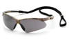 A high-definition 3/4 view of the Pyramex PMXTREME SCM6320STP safety glasses, featuring a forest camouflage frame paired with a smoke gray anti-fog lens. The gray lens is optimized for bright outdoor light to reduce glare and eyestrain, while the high-performance anti-fog coating ensures clear vision during temperature changes or high-exertion tasks. These glasses feature the signature PMXTREME 10-base curve panoramic lens for maximum wraparound side protection and a wide field of vision. Designed for all-day comfort, the camo temples are ventilated for airflow and include a built-in rubber nose piece for a secure, non-slip fit. This 23.1-gram model is ANSI Z87.1-2020 high-impact certified and comes with an included black lanyard cord for added security.