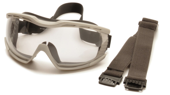 This product view highlights the versatility of the Pyramex Capstone® 600 (G604T2) by showcasing its interchangeable strap system. The goggle is pictured alongside both the adjustable cloth strap for standard comfort and the neoprene strap, which is ideal for environments requiring chemical resistance or easy decontamination. This angle clearly displays the wide clear H2X anti-fog lens and the flexible gray TPE body, which is specifically engineered with an Over-the-Glass (OTG) fit to accommodate prescription eyewear. The image also shows the indirect ventilation ports that contribute to its D3 (Splash) and D4 (Dust) ratings.