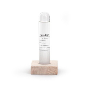 This image shows a glass capsule on a wood base. This image shows a glass capsule on a wood base.