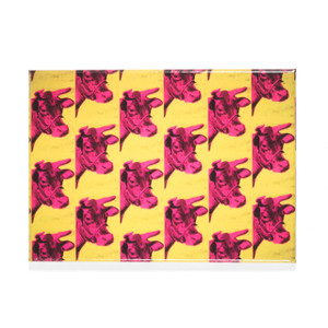 A rectangular magnet with a pink cow pattern on a yellow background. A rectangular magnet with a pink cow pattern on a yellow background.