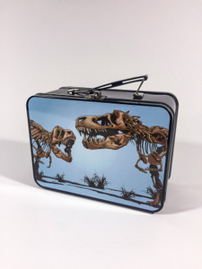 The front of the black metal lunch box features the T.Rex skeletons head to head decal on a light blue background.