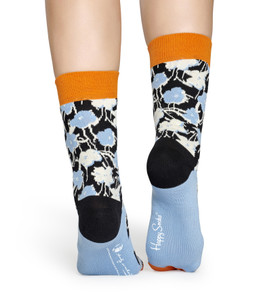 Legs of someone wearing black socks with blue and white flowers. Legs of someone wearing black socks with blue and white flowers.