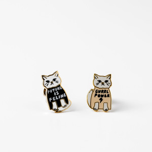 image of a pair of small earrings shaped like cats.