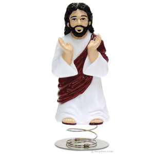a Jesus figurine on a metal coiled spring.