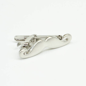 Close-up of mustache-shaped tie clip. Close-up of mustache-shaped tie clip.