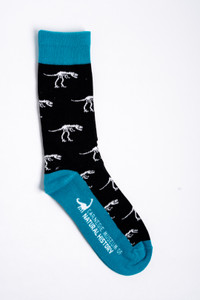 Crew sock cotton nylon blend, teal band and heel, black body with white T-Rex skeletons. Carnegie Natural History logo on bottom of sock. Crew sock cotton nylon blend, teal band and heel, black body with white T-Rex skeletons. Carnegie Natural History logo on bottom of sock.