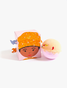 Pink box featuring Maya Angelou illustration next to yellow and pink bath balm. Pink box featuring Maya Angelou illustration next to yellow and pink bath balm.