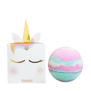 Pop-up white unicorn box next to pink, white, and blue bath balm. Pop-up white unicorn box next to pink, white, and blue bath balm.