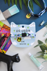 Baby blue cat collar featuring clouds and green apples on cat-shaped backing card. Baby blue cat collar featuring clouds and green apples on cat-shaped backing card.