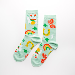 Mint green socks featuring lucky cats, dice, four leaf clovers, horseshoes, and rainbows. Mint green socks featuring lucky cats, dice, four leaf clovers, horseshoes, and rainbows.