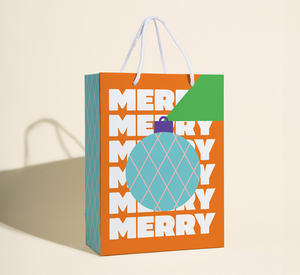 Rope handle gift bag, red background, image of an round ornament, repeated text in white, "merry:".