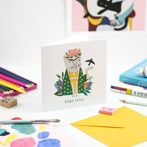 Greeting card featuring gray cat donned in florals, dressed like Frida Kahlo. Greeting card featuring gray cat donned in florals, dressed like Frida Kahlo.