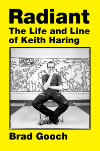 Yellow book cover with a black and white photograph of the artist Keith Haring. Title text in black: Radiant The life and line of Keith Haring. Yellow book cover with a black and white photograph of the artist Keith Haring. Title text in black: Radiant The life and line of Keith Haring.