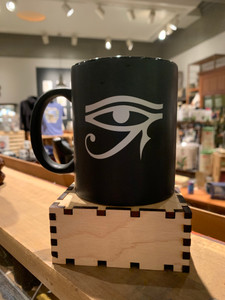 shows black mug with silver eye of Horus