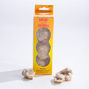 A yellow and orange box with three round, unbroken geodes inside next to three broken open geodes with white crystals. A yellow and orange box with three round, unbroken geodes inside next to three broken open geodes with white crystals.