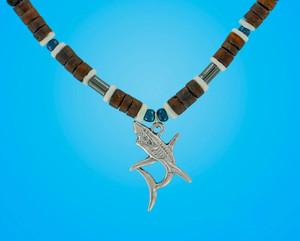 A metal shark pendant hanging from a black cord with brown beads