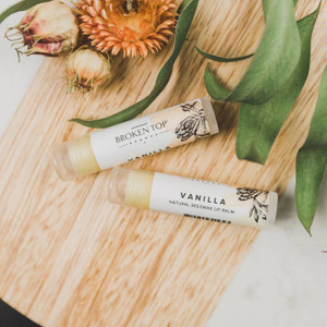 two lip balms on a table two lip balms on a table
