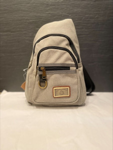 front of bag has 3 pockets a large, medium and small with zippers. front of bag has a key ring attached and a decorative metal plate with trees embossed on it front of bag has 3 pockets a large, medium and small with zippers. front of bag has a key ring attached and a decorative metal plate with trees embossed on it