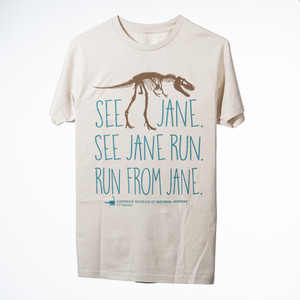 bone colored T with T. rex fossil printed in brown and the words "see jane. see jane run. run from jane." printed in agave lettering