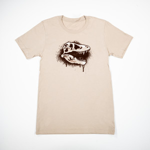 tan T-shirt with a graffiti style T. Rex skull printed on it tan T-shirt with a graffiti style T. Rex skull printed on it