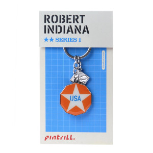 Robert Indiana New Glory penny design keychain in it's packaging. Robert Indiana New Glory penny design keychain in it's packaging.