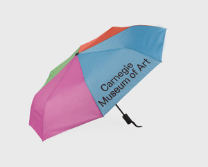 Carnegie museum of art umbrella open facing left. Colorblock blue, pink, orange, and green. Carnegie museum of art umbrella open facing left. Colorblock blue, pink, orange, and green.