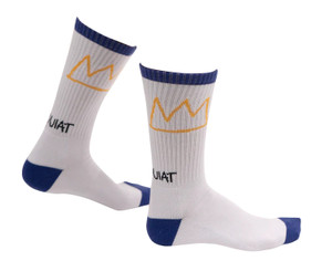 Basquiat white socks with blue trim. Yellow crown on ankle with Basquiat name written below. Side view. Basquiat white socks with blue trim. Yellow crown on ankle with Basquiat name written below. Side view.