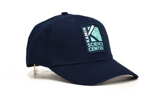 A dark blue baseball cap with the Kamin Science Center logo