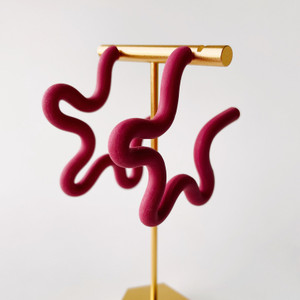 Mulberry color, Squiggle polymer clay earrings on gold stand. Mulberry color, Squiggle polymer clay earrings on gold stand.