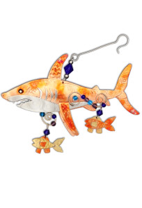 A coppery metal ornament in the shape of a Great White Shark with two mall fish below its body A coppery metal ornament in the shape of a Great White Shark with two mall fish below its body
