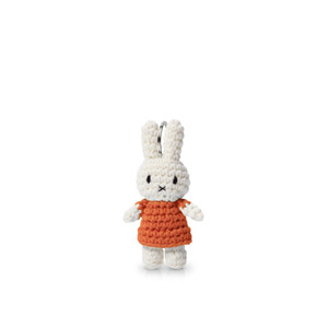 Miffy (White bunny) wearing an orange dress.  Keychain.
