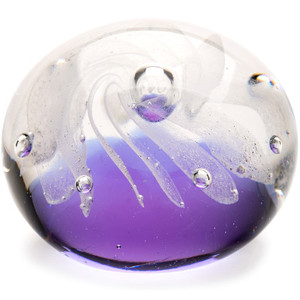 A semispherical paperweight made with swirls of white and clear glass over an indigo base to resemble the Milky Way Galaxy