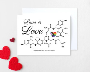 A greeting card with the molecular model of oxytocin and the Progress Pride Flag in a heart