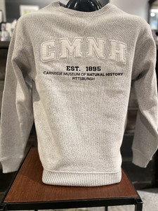 white sweater with cmnh written across the chest