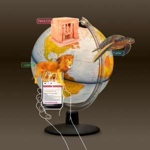 A lit globe showing Earth's political borders with examples of three points of interest highlighted by the free app that comes with the globe