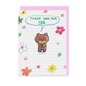 White card cover made to look like lined paper , illustration of a brown bear holding flowers, and small flower doodles.