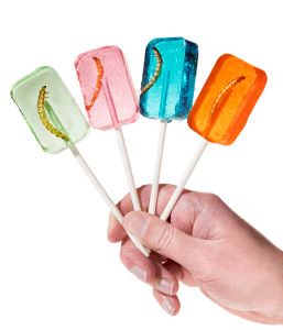 a hand holding all 4 flavors of lollipop