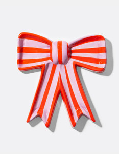 Front view of ceramic trinket tray in the shape of a bow. Color Pink and orange vertical stripe.