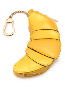 Croissant bag charm with brass hardware. Bag inside croissant shaped holder.