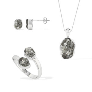 A pair of stud earrings, a chain pendant, and a bypass ring featuring meteorites set in sterling silver
