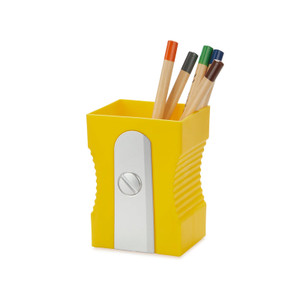 Yellow pen holder that is shaped like a giant pencil sharpener. Photographed unboxed, holding 4 colored pencils.