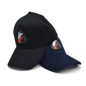 Two baseball caps, one black and one navy, with the triangular mission patch of Artemis II