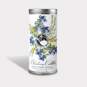 A photo of the can in which the tea bags come in. There is an illustration of blueberries, rooibos, and lavender featured, along with the brand logo and information about the product. This text includes: "Blueberry Cobbler", "Blueberry Rooibos Herbal Tea", "12 Premium Tea Satchels" and "Brews 24 Cups". The net weight of the product ".85oz (24g)" is also listed.