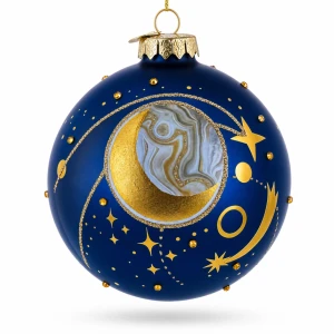 A dark blue blown-glass ornament  with moons and stars seen from the front