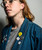 Image of a person wearing many pins including a gorilla head enamel pin. Image of a person wearing many pins including a gorilla head enamel pin.