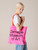 Carnegie Museum of art pink tote with red handle, being carried over the shoulder.
